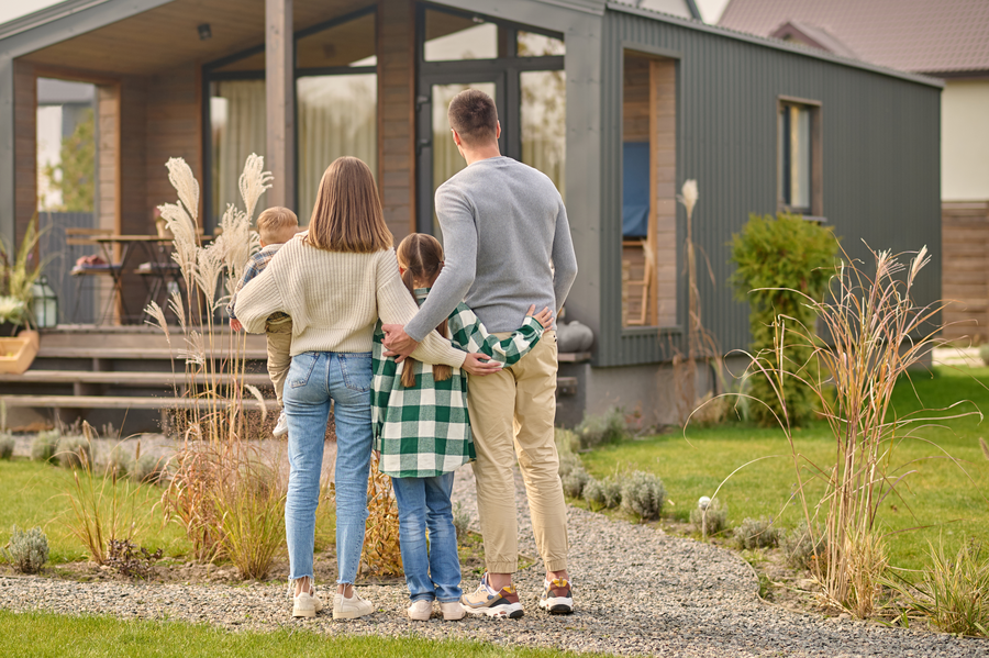 A family outside their new home